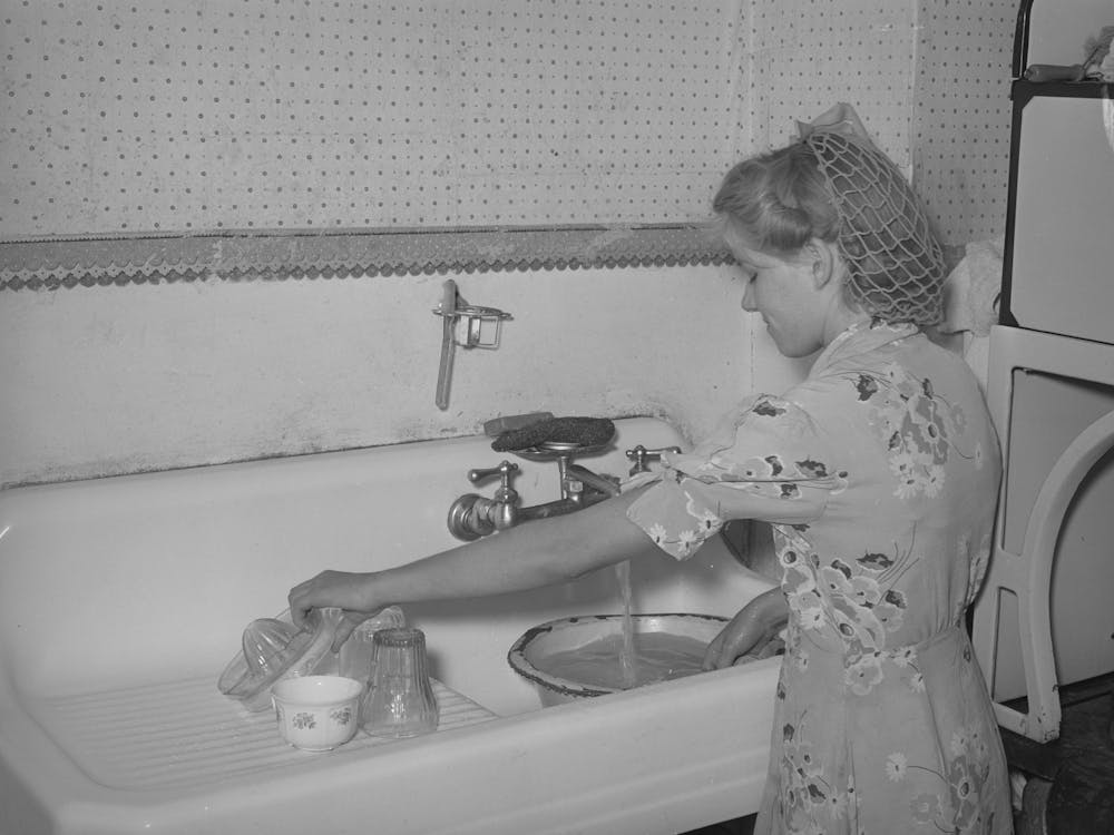 Daughter Of Mormon Farmer Washing Dishes, In Most Of The Mormon Communities Running Culinary Water Is