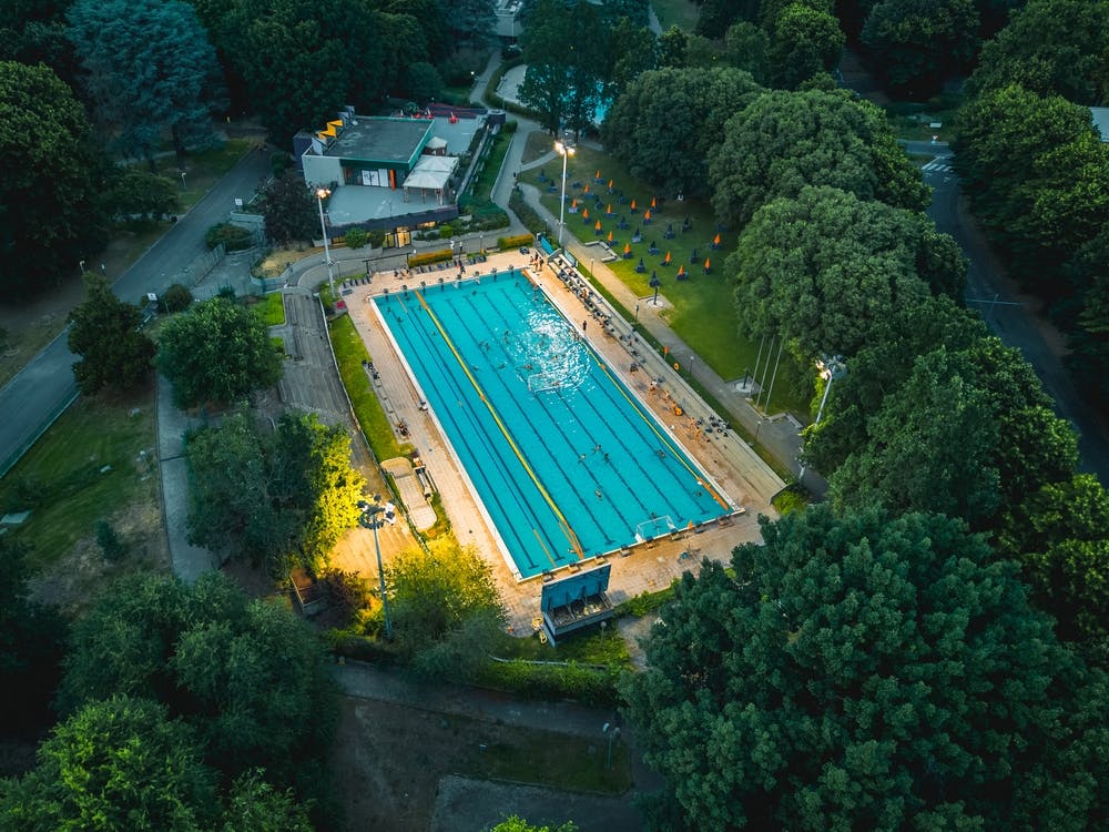 Poster swimming pool with athletes training water polo. San Donato Milanese, Italia