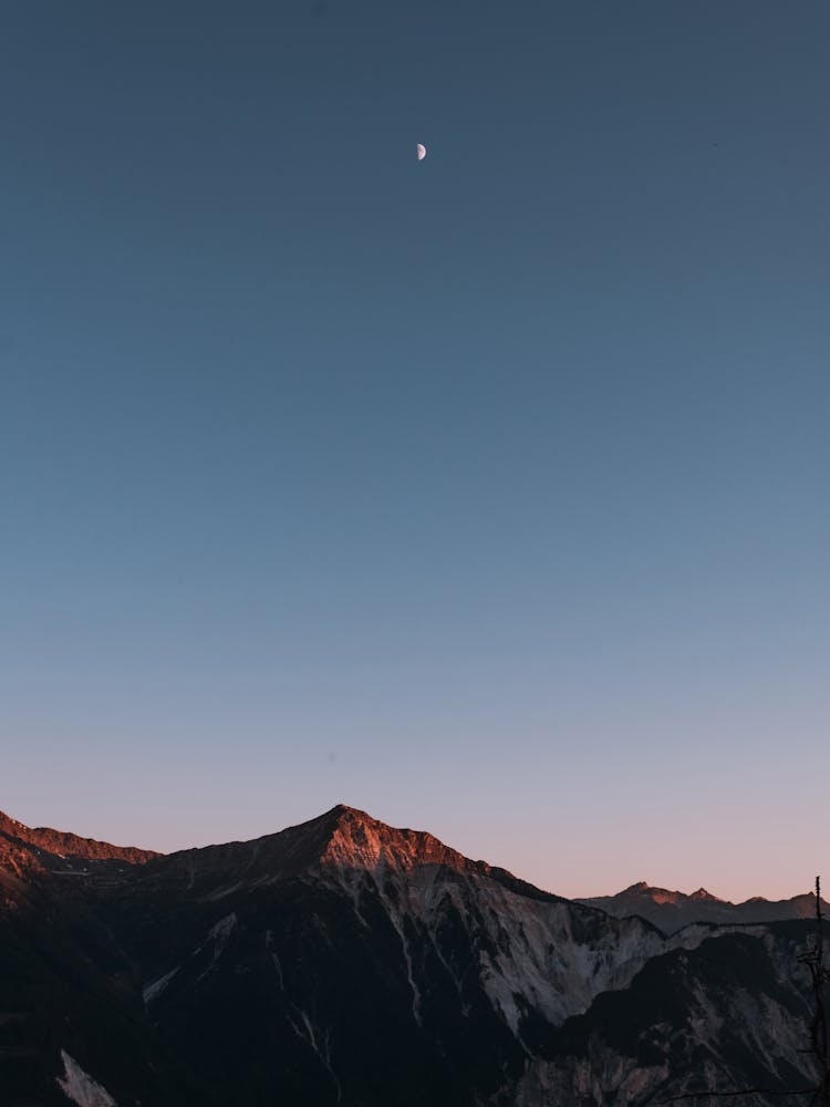 Swiss Alps during sunset with the moon