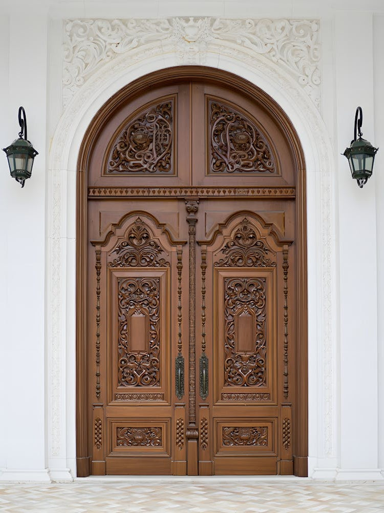Grand Entrance – An Ornate Wooden Doorway with Intricate Carvings