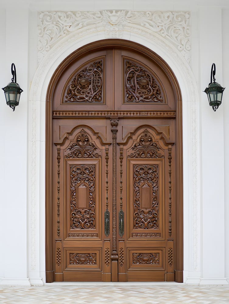 Grand Entrance – An Ornate Wooden Doorway with Intricate Carvings