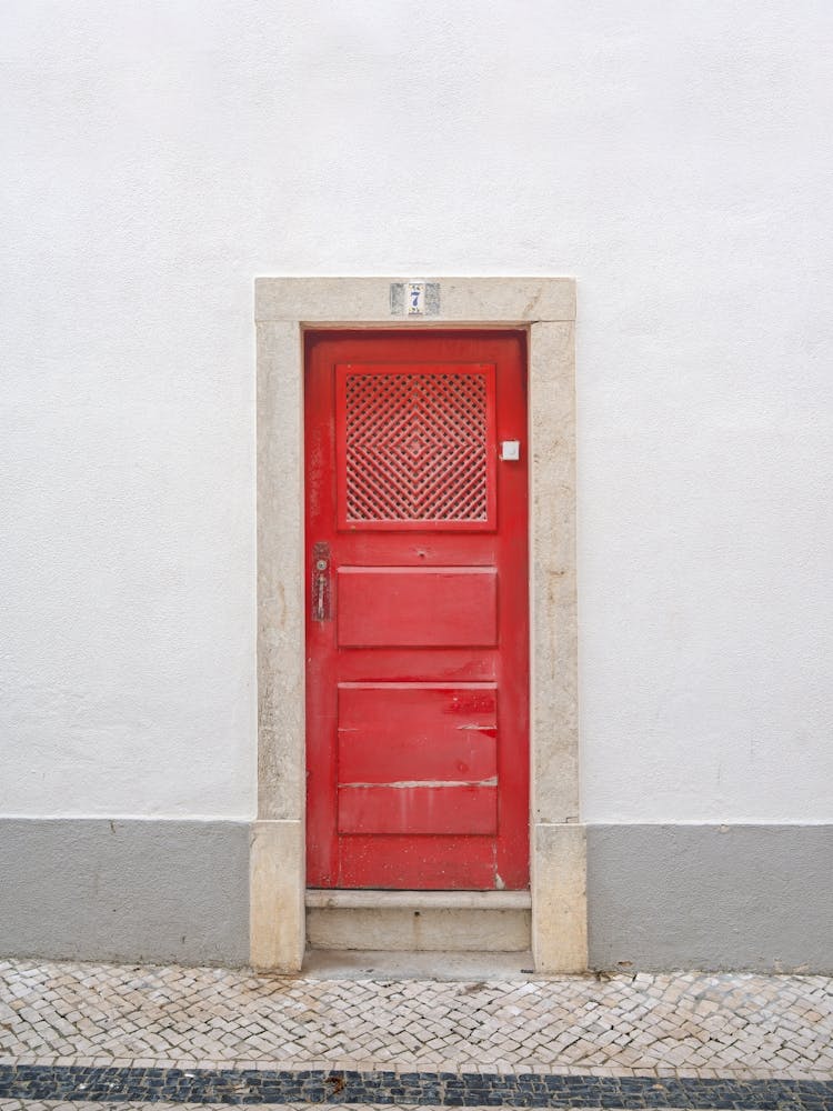 The red door nr. 7 in Ericeira, Portugal - minimalist summer street and travel photography by Christa Stroo Photography