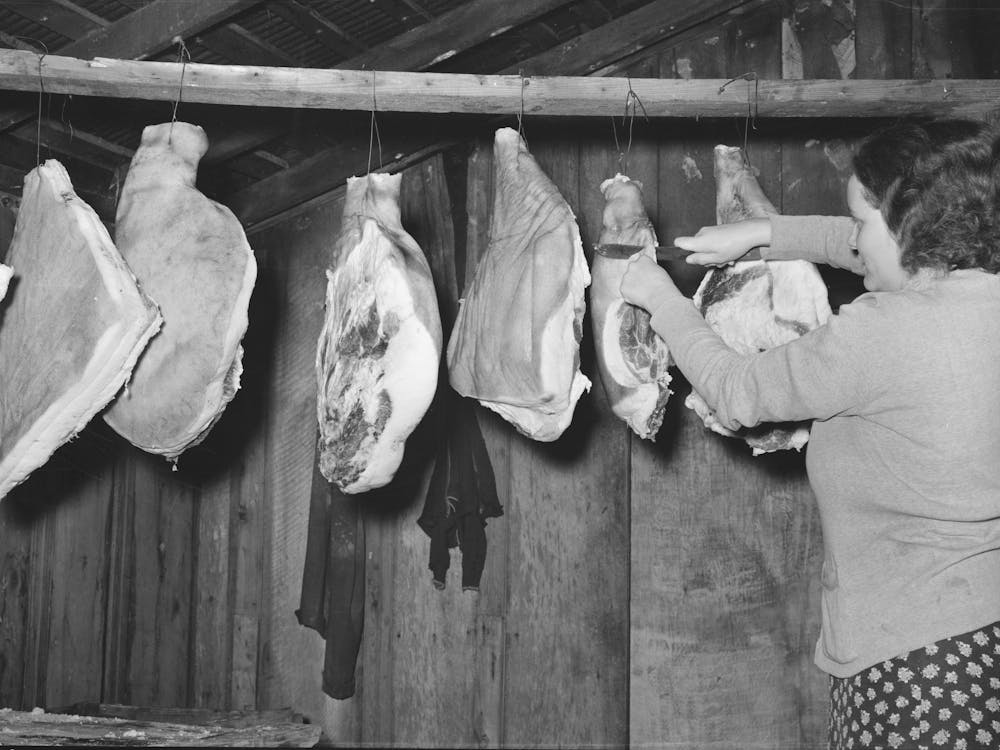 Wife Of Tenant Farmer Cutting Piece Of Ham In Smokehouse Near Pace, Mississippi, Background Photo For