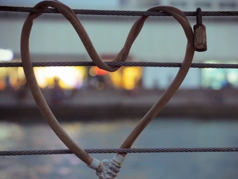 Heart Shaped Padlock Locked Metal Cables During Twilight Time