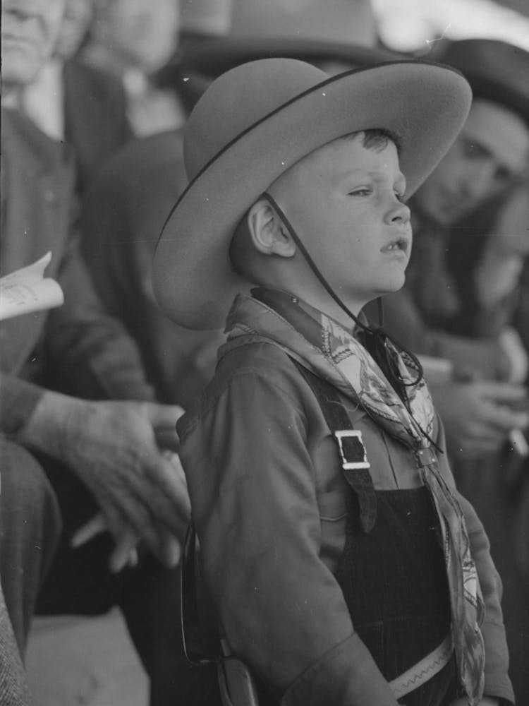 Youngster In Cowboy Costume Watching The Rodeo At The San Angelo Fat Stock Show, San Angelo, Texas By Russell Lee
