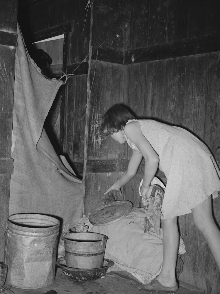 Mexican Girl Standing Over Pan Of Hot Coal In Which Pail Of Water Is Heating, Robstown, Texas By Russell Lee