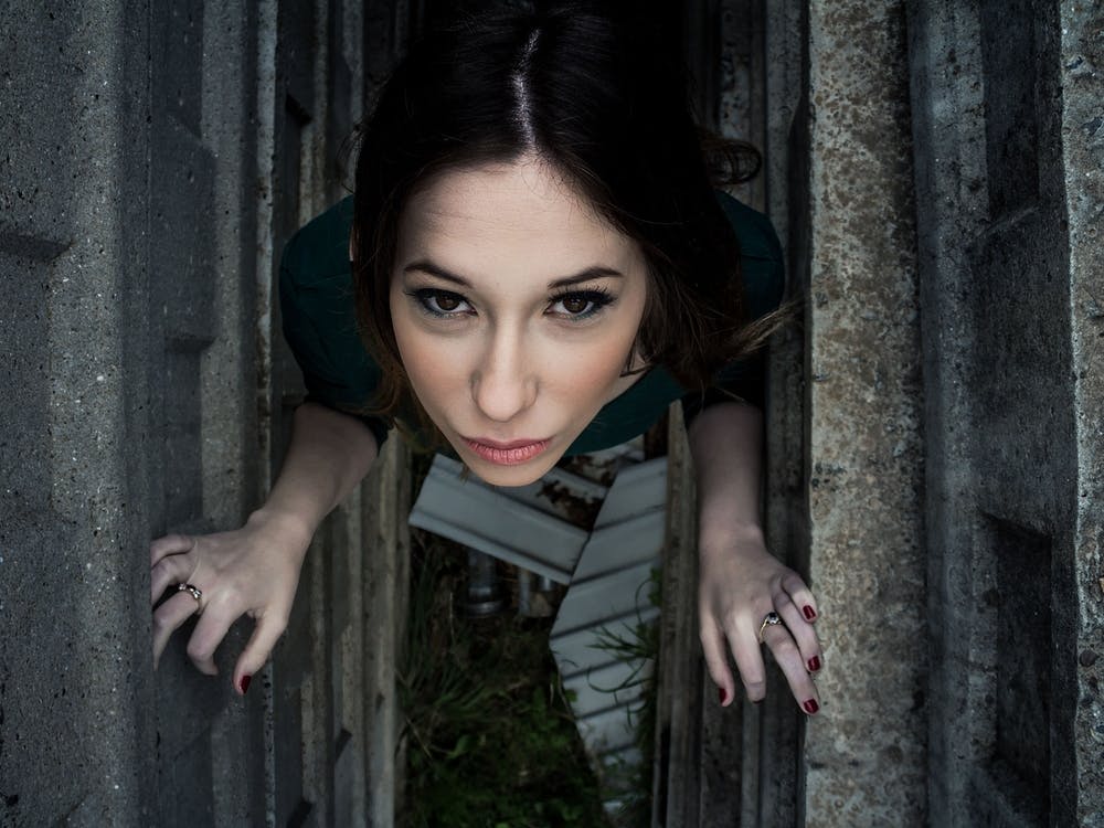Beautiful Brunette Woman Posing Outdoor In Abandoned Industrial Place