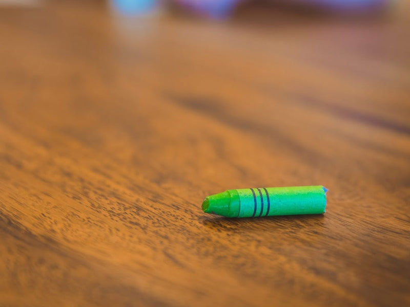 Green Color Pastel Crayon On Brown Wooden Table