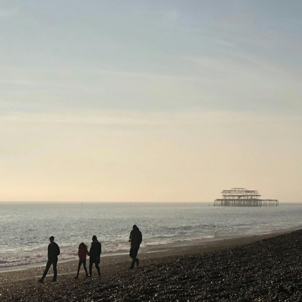 Silhouette Of Family On Brighton Beach Square