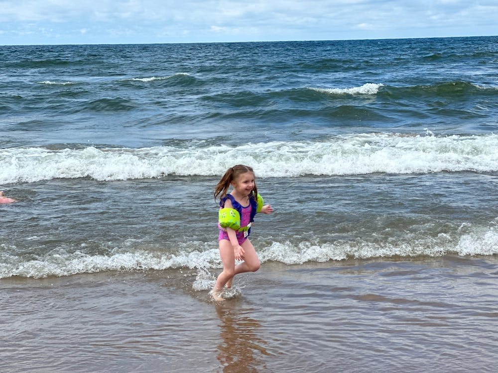 Little Girl Running In The Ocean