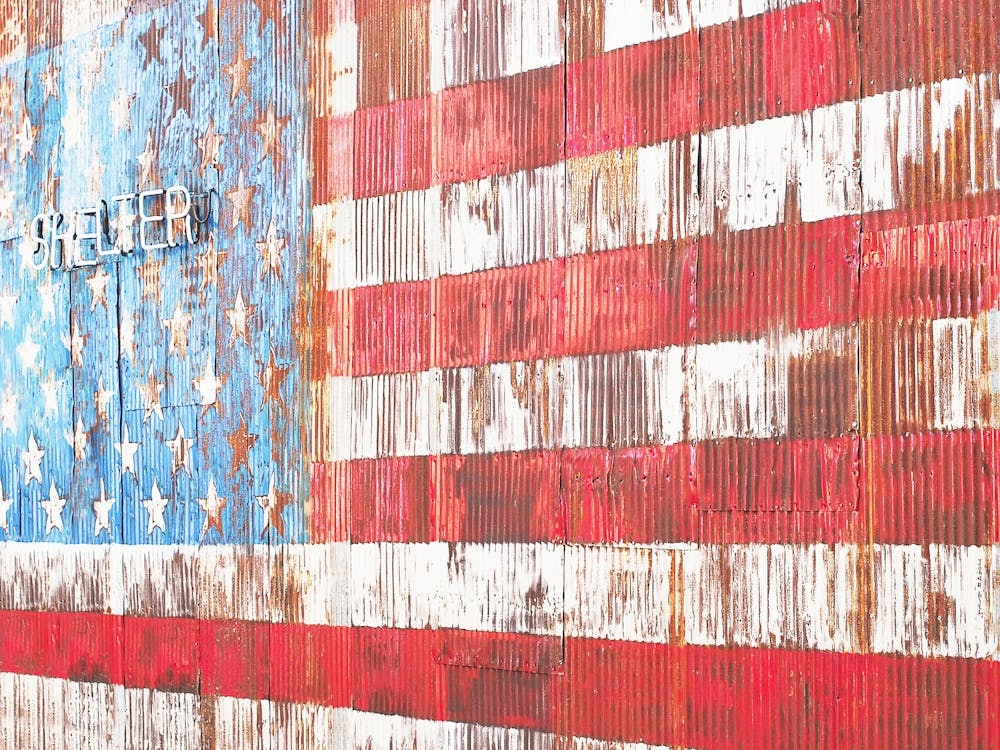 New York, USA I American flag wall in rusted metal for US street art culture photography in Brooklyn and arty Williamsburg shelter with minimalist geometric lines and blue white red stars of the United States