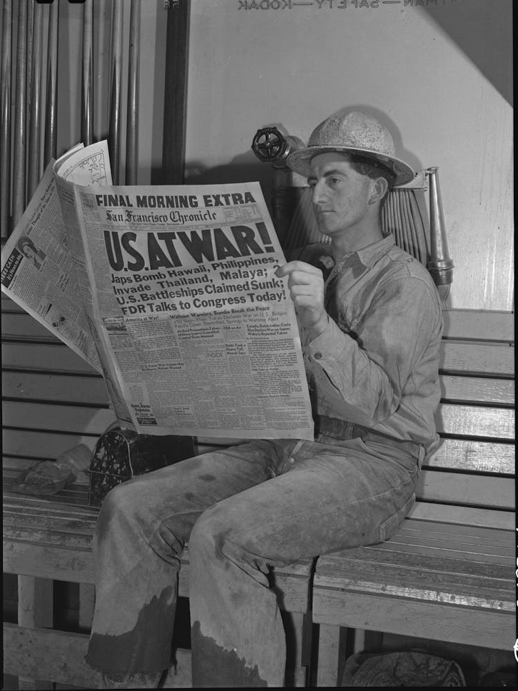Workman At Shasta Dam Reads War Extra, Shasta County, California By Russell Lee