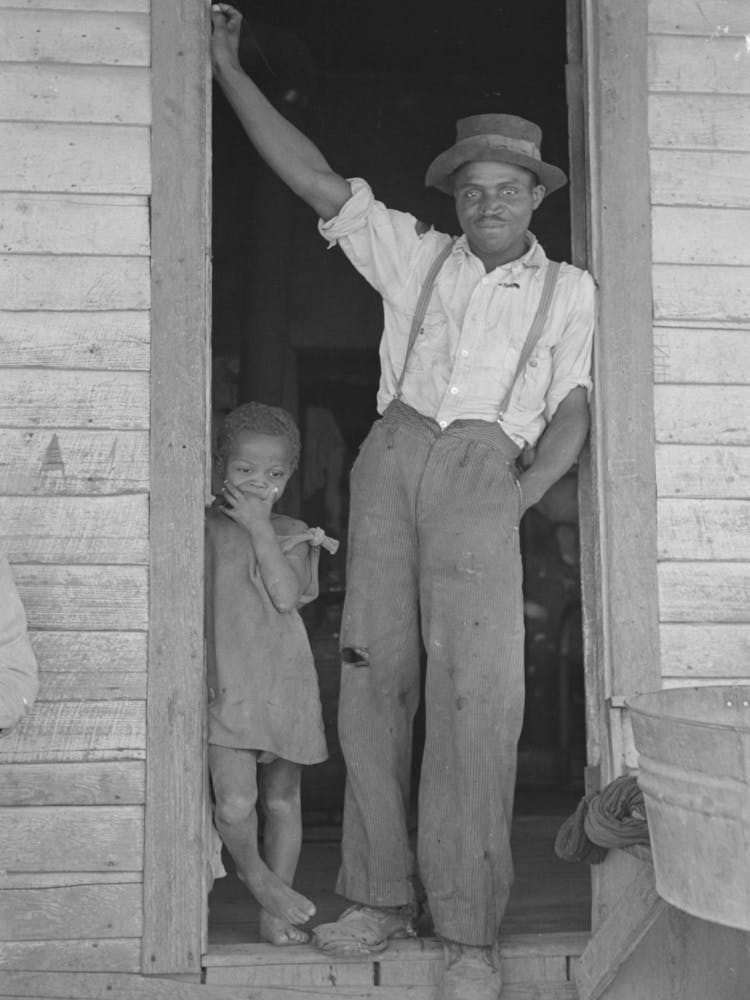 Sharecropper And Young Daughter Standing In Doorway Of Shack Home, New Madrid County, Missouri By Russ
