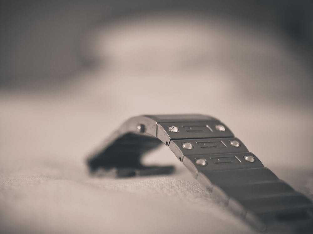 Close Up Of A Metal Watch Strap Is On A White Cloth