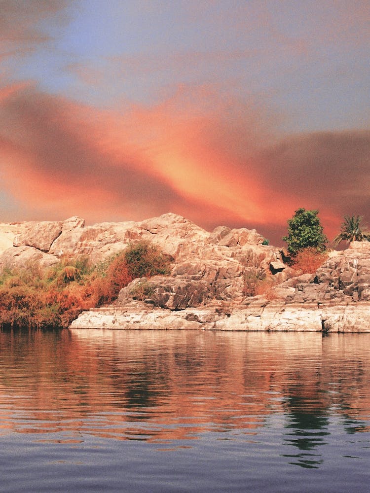 Nile River With Rocks At Sunset