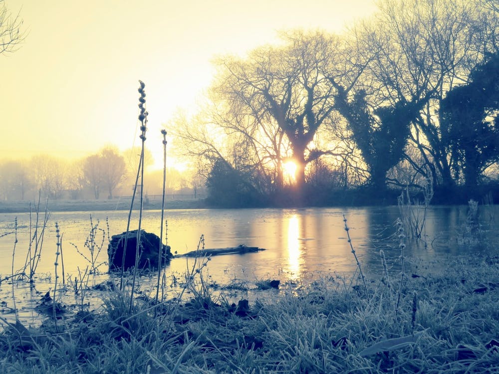 Sunrise Over A Frozen Lake frost countryside