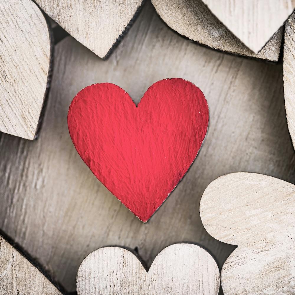 Red wooden love heart background for a romantic message for Valentines day