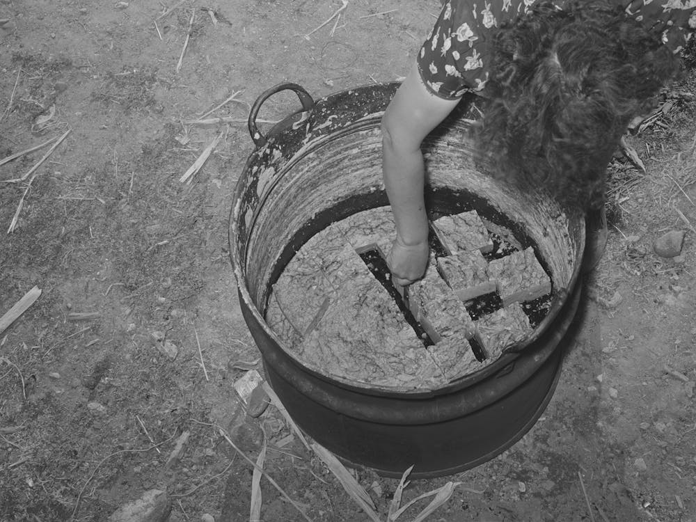 Spanish American Woman Cutting Soap Which She Made In This Kettle, Near Taos, New Mexico By Russell Lee