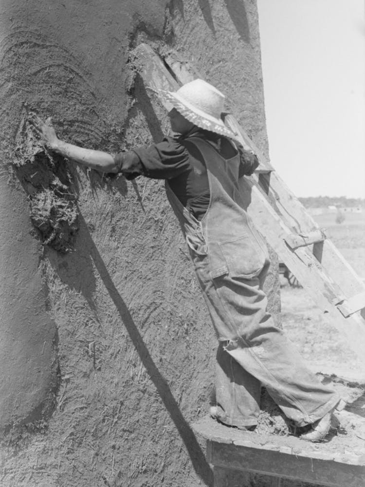 Spanish American Woman Plastering Adobe House, Chamisal, New Mexico By Russell Lee 1
