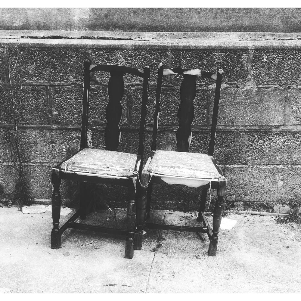 Two Chairs Against A Wall
