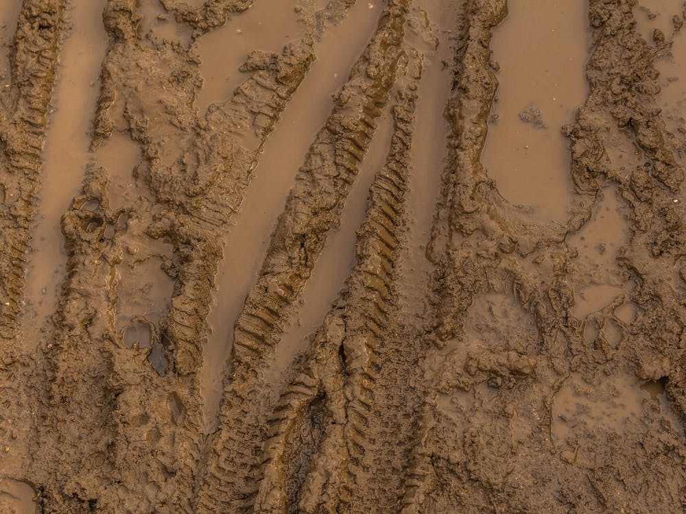 Texture Of Wet Brown Mud With Bicycle Tyre Tracks 5
