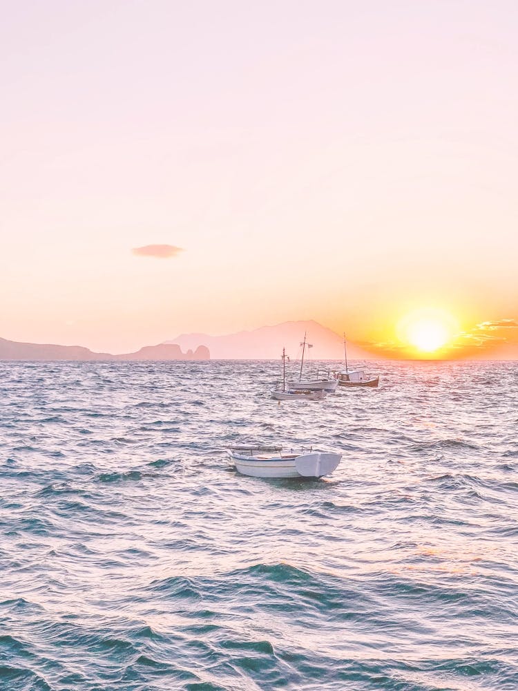 Milos, Greece I Summer pastel pink aesthetic sunset photography in the fishing village of Klima with its boats on the Mediterranean sea in the mountains of the wild boho nature on Cyclades islands like Santorini