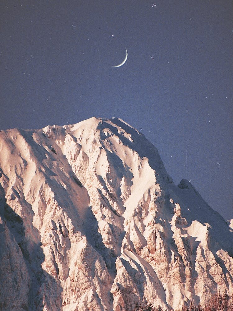 New Moon And A Snowy Mountain