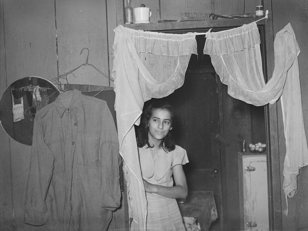 Mexican Girl In Doorway Between Living Room And Kitchen, San Antonio, Texas By Russell Lee