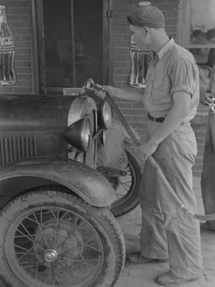 Filling Radiator Of Migrant Car With Water, This Is Done Frequently, As These Radiators Usually Leak