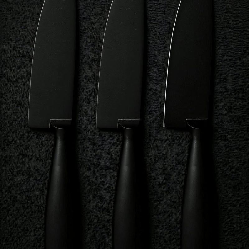 Three Knives On A Black Surface