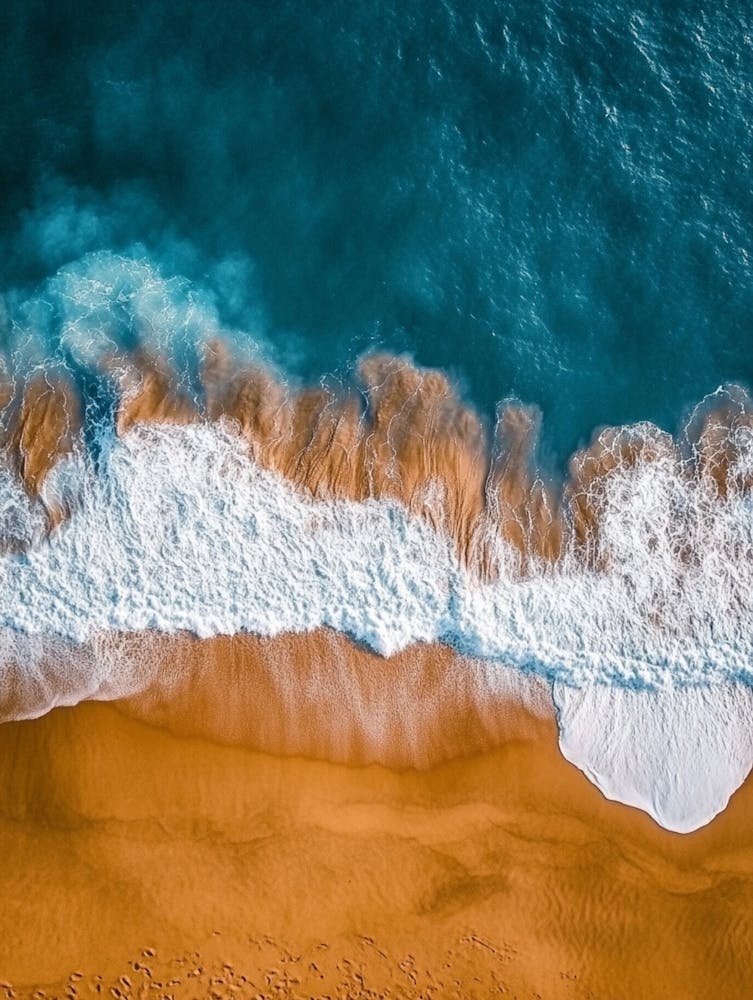 Aerial View Of A Beach With Waves