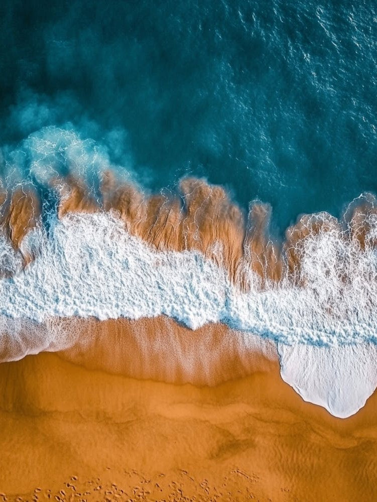 Aerial View Of A Beach With Waves