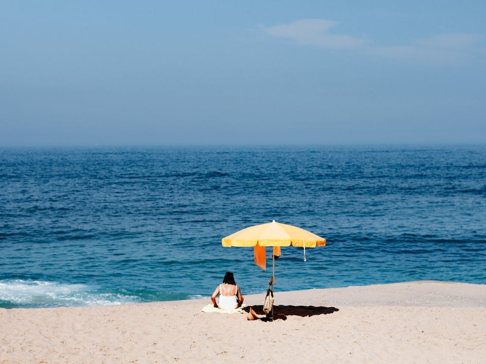 Le Parasol Jaune La Mer Bleue Et La Femme Sur La Plage Portugal Voyage