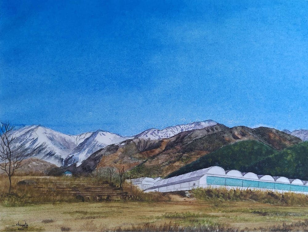 Green house and the snow capped mountains