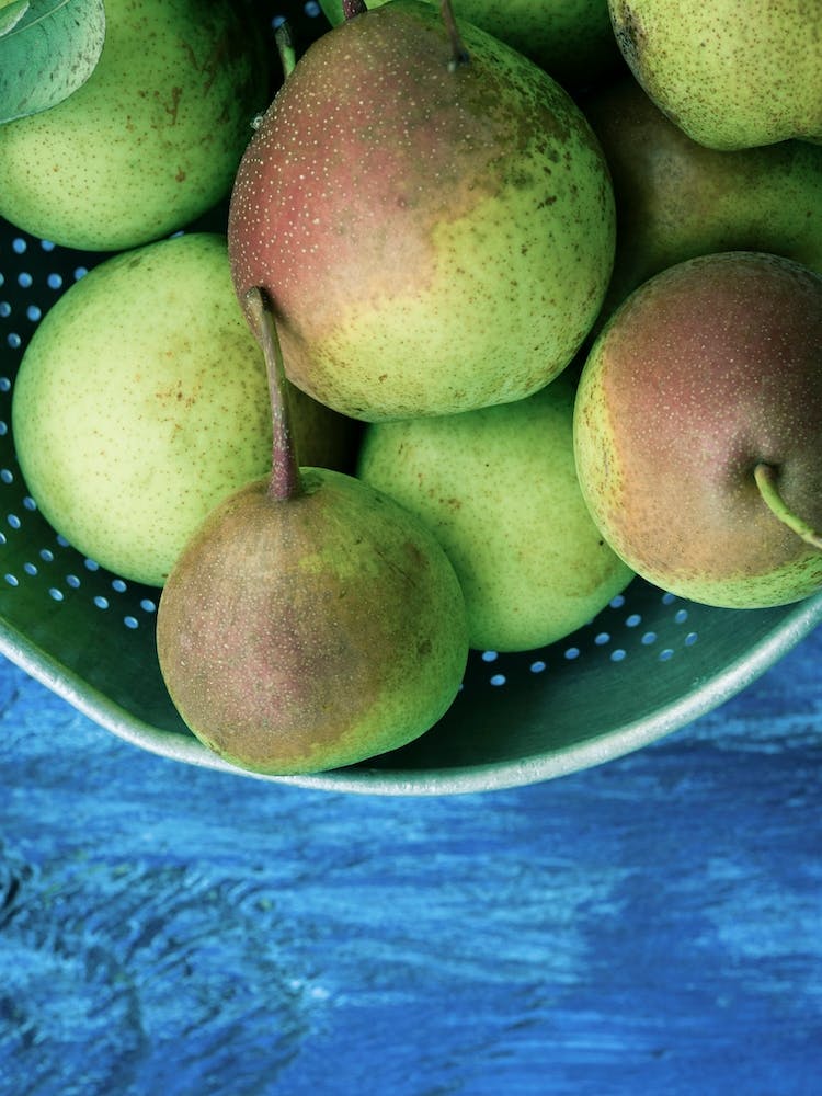 Green Pears On Blue Table