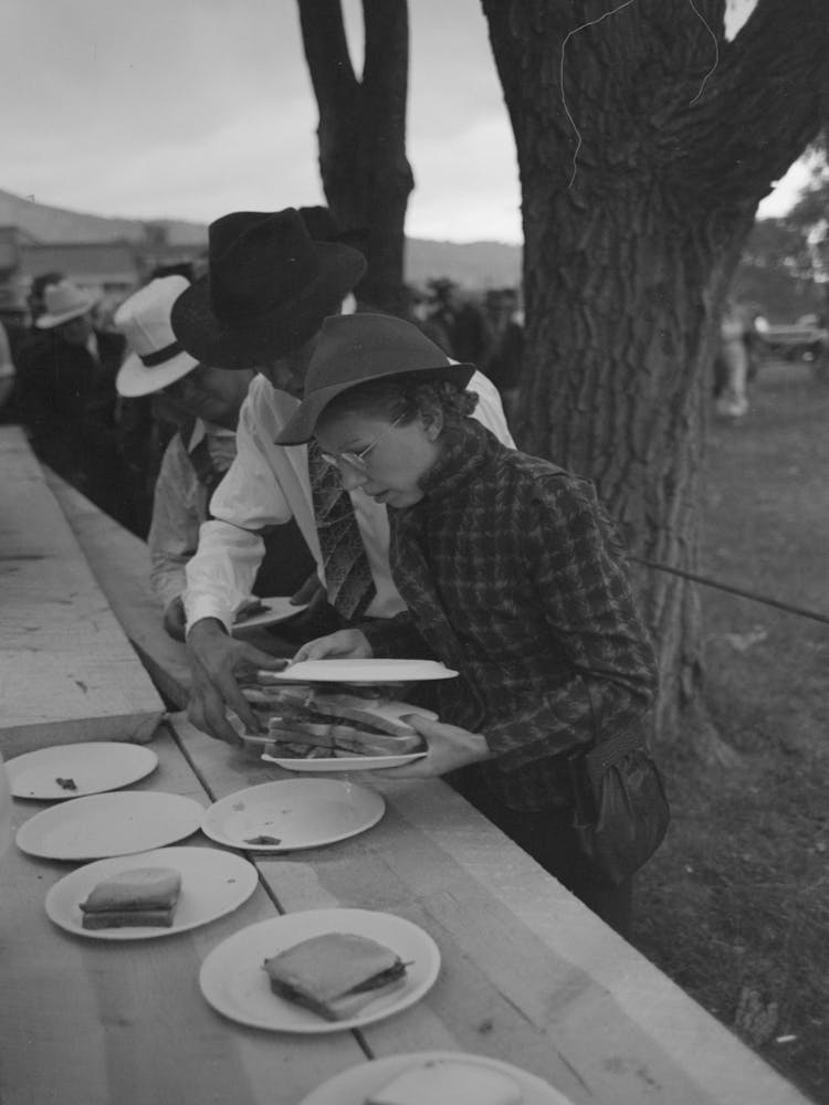 Covering A Plate Of Barbecue Sandwiches With Another Plate To Protect The Food From The Rain, Labor Day At
