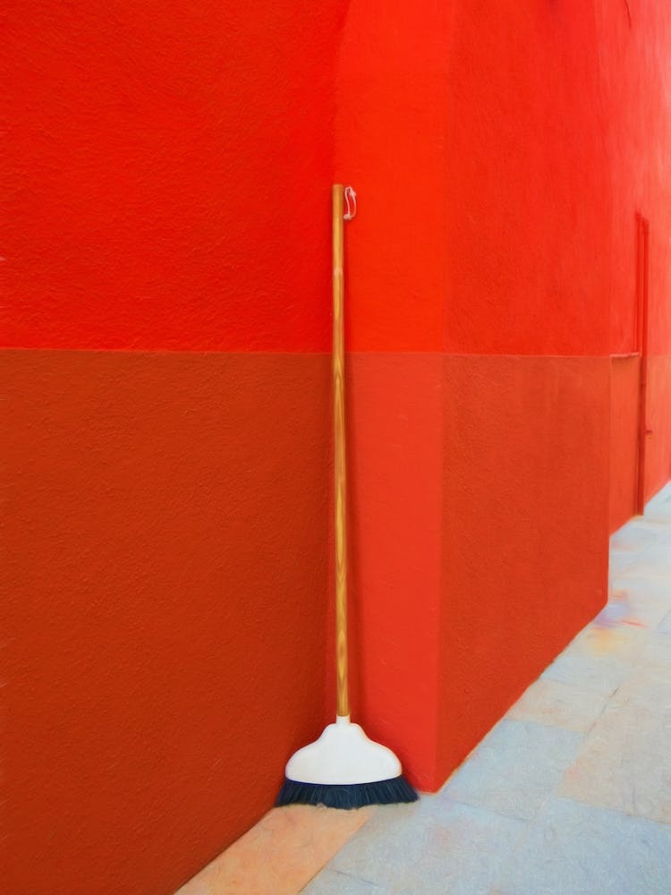 Sweeping Brush & Red Painted Wall