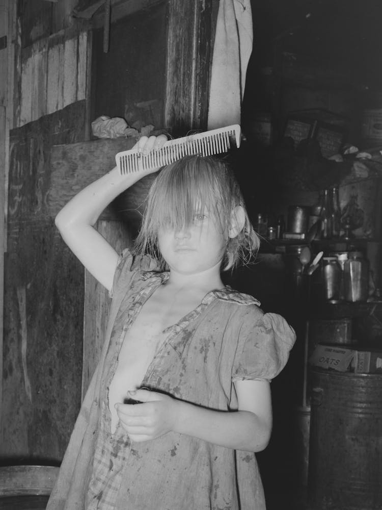 Little Girl Combing Hair, She Lives In Camp Near Mays Avenue