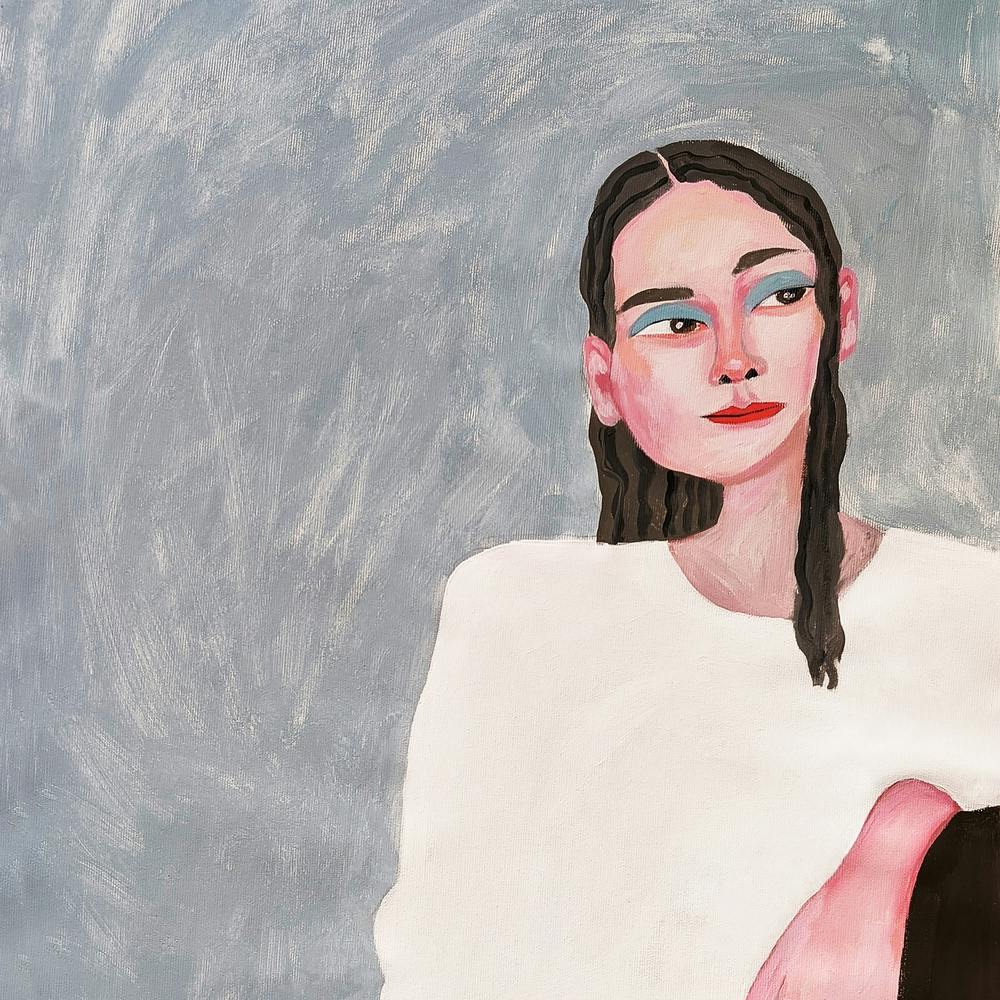 Portrait of a woman in white on a gray background