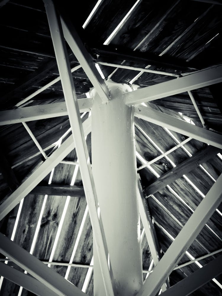 White Iron Pillars With Wooden Beams Above 2