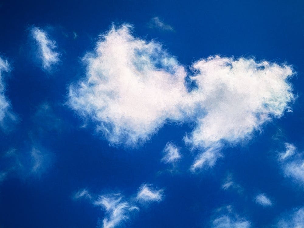 Sunlit Clouds In A Blue Sky