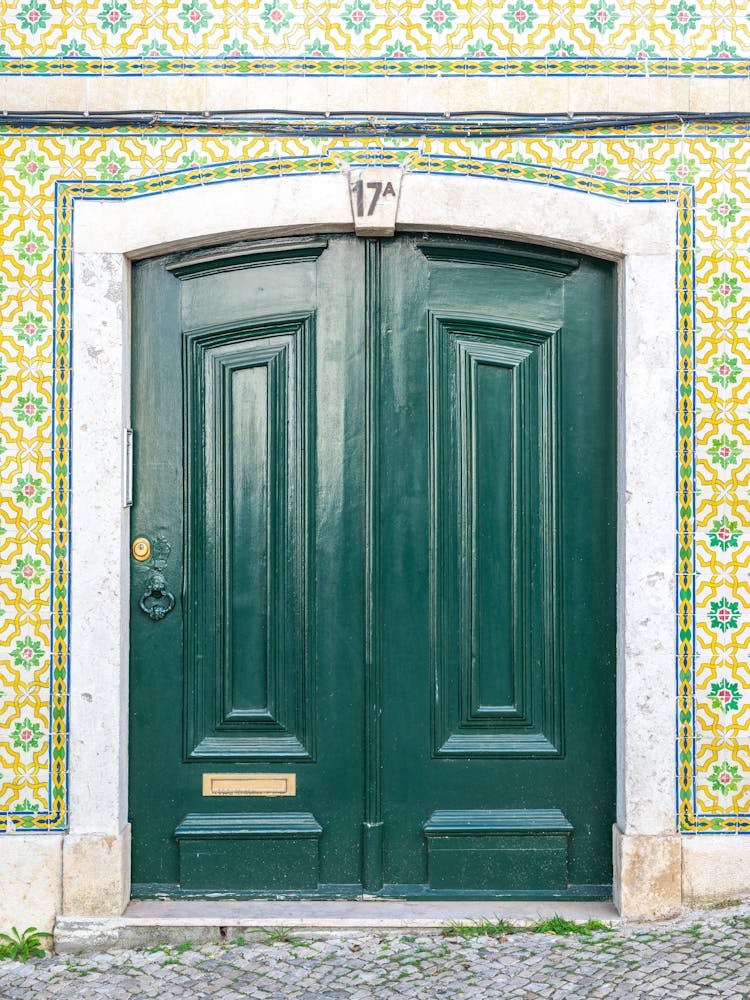 The green door nr. 17A in Alfama, Lisbon, Portugal - summer travel photography by Christa Stroo Photography