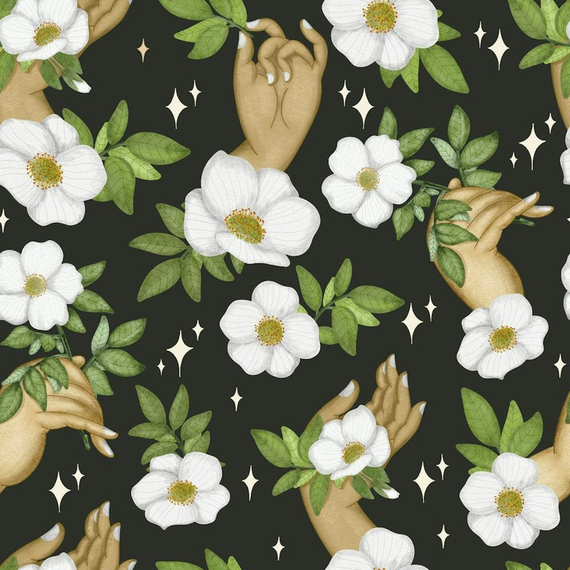 Delicate hand holding a wild flower