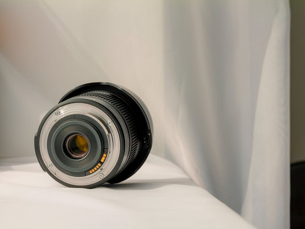 Black Camera Zoom Lens On White Cloth