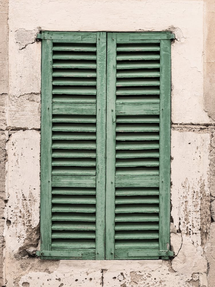 Old wooden window shutters and grunge wall background