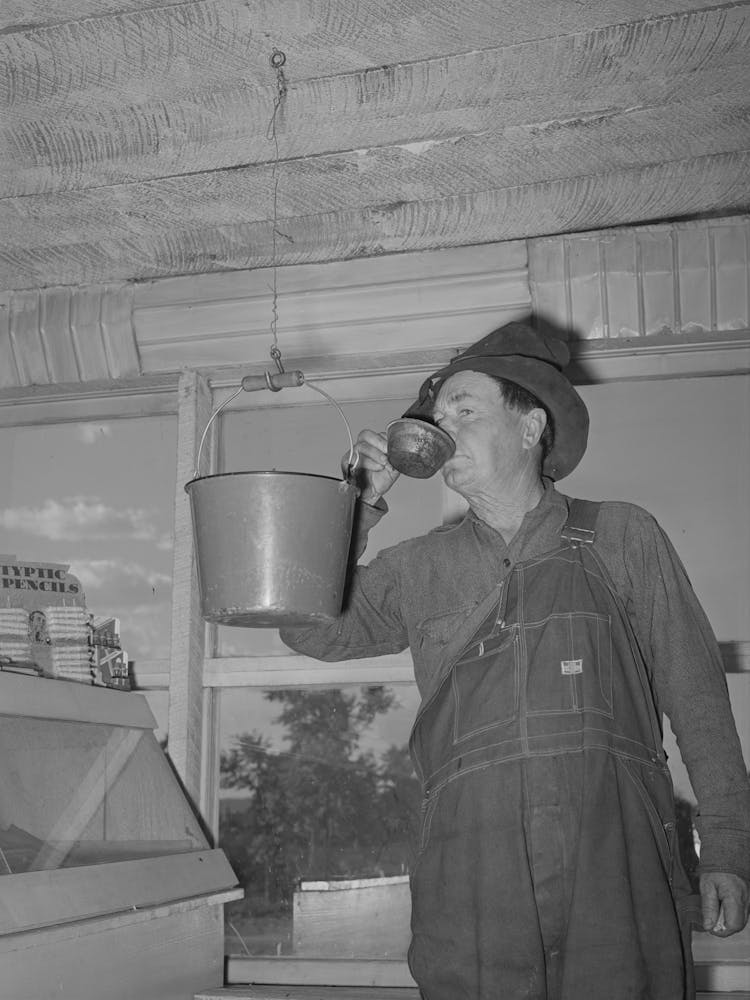 Farmer Drinking Water From Bucket Which Hangs In The General Store, Pie Town, New Mexico By Russell Lee