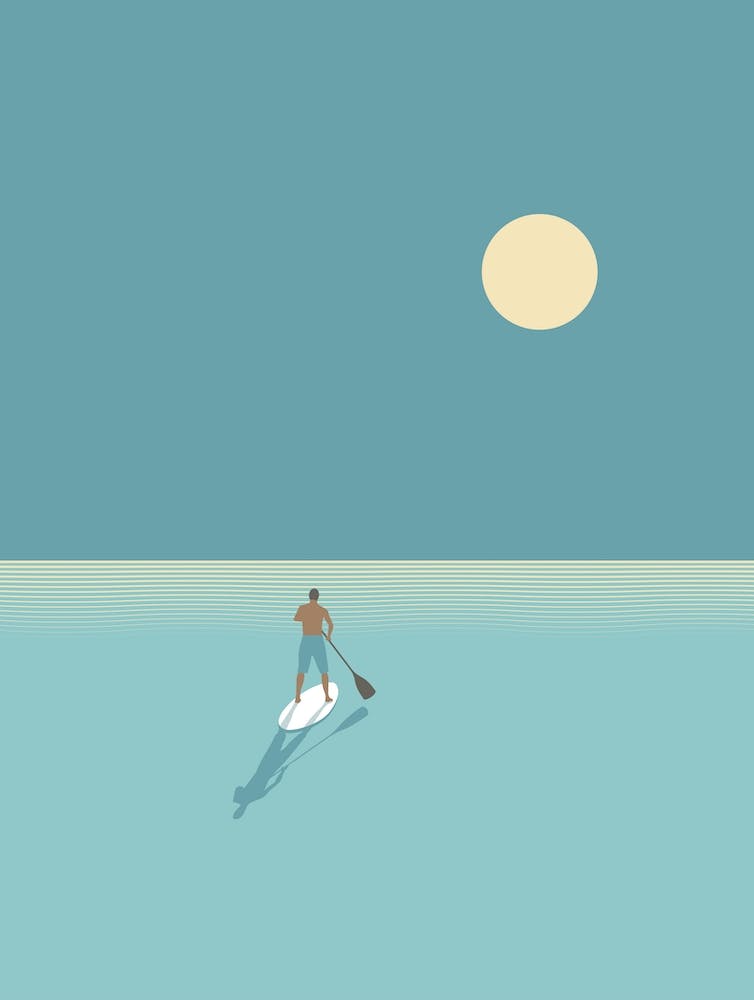 Minimal paddle boarder at sunset
