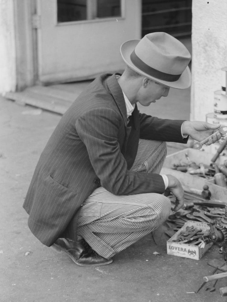 Man Looking At Wrench, Market Square, Waco, Texas By Russell Lee