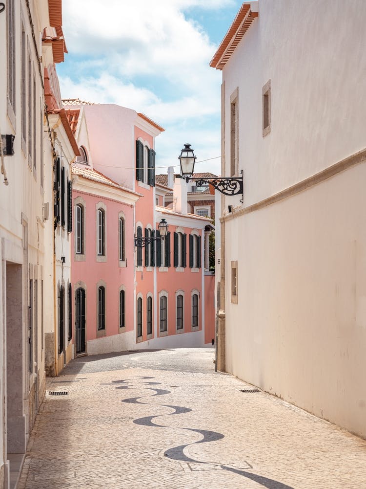 Pastel houses in Cascais, Portugal - wanderlust vintage street and travel photography by Christa Stroo