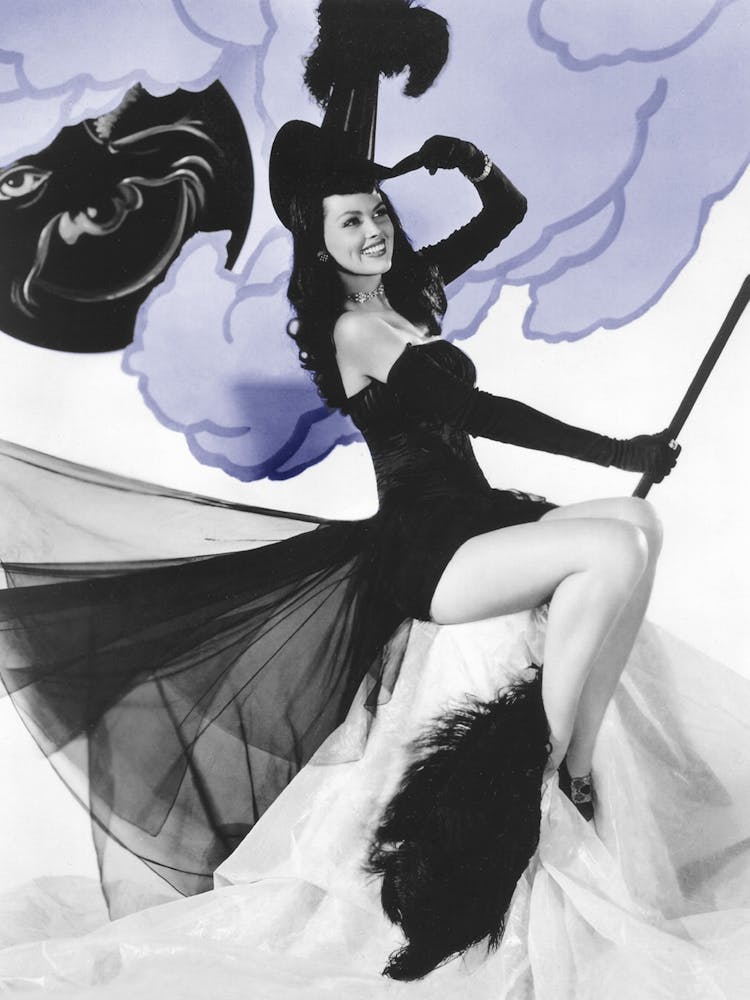 Black Pin Up Witch Posing On A Broom And A Winking Moon